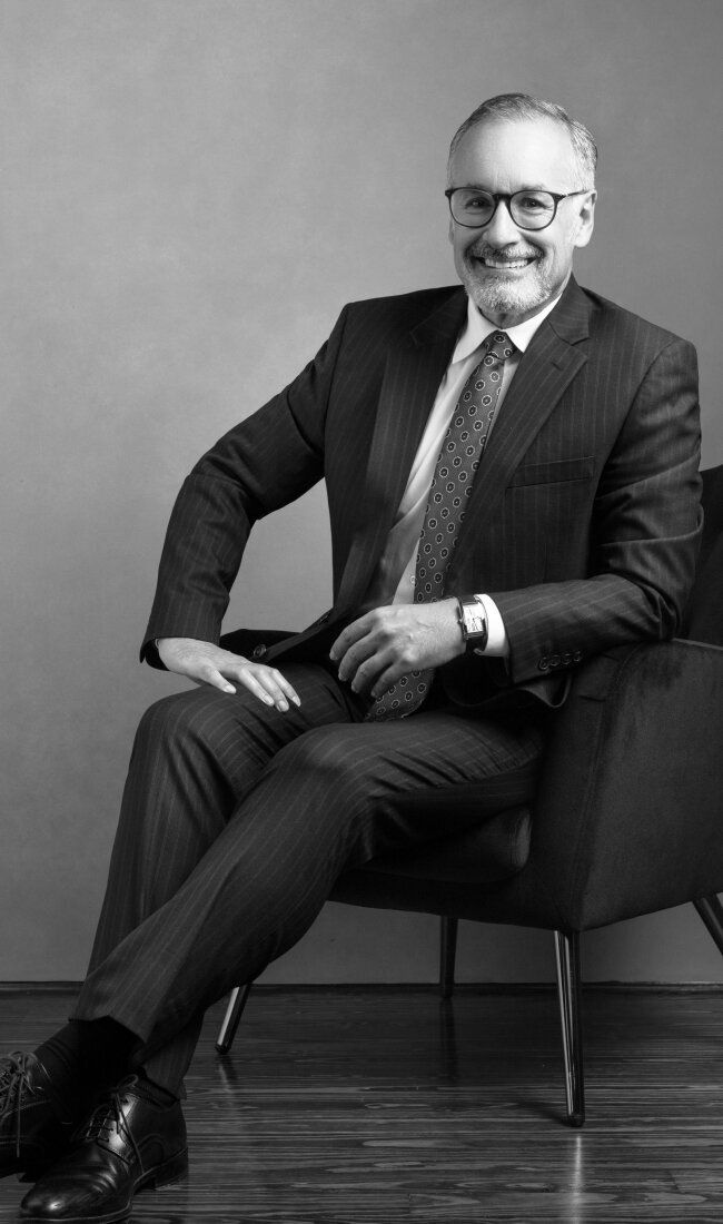 Businessman in suit sitting on a chair.