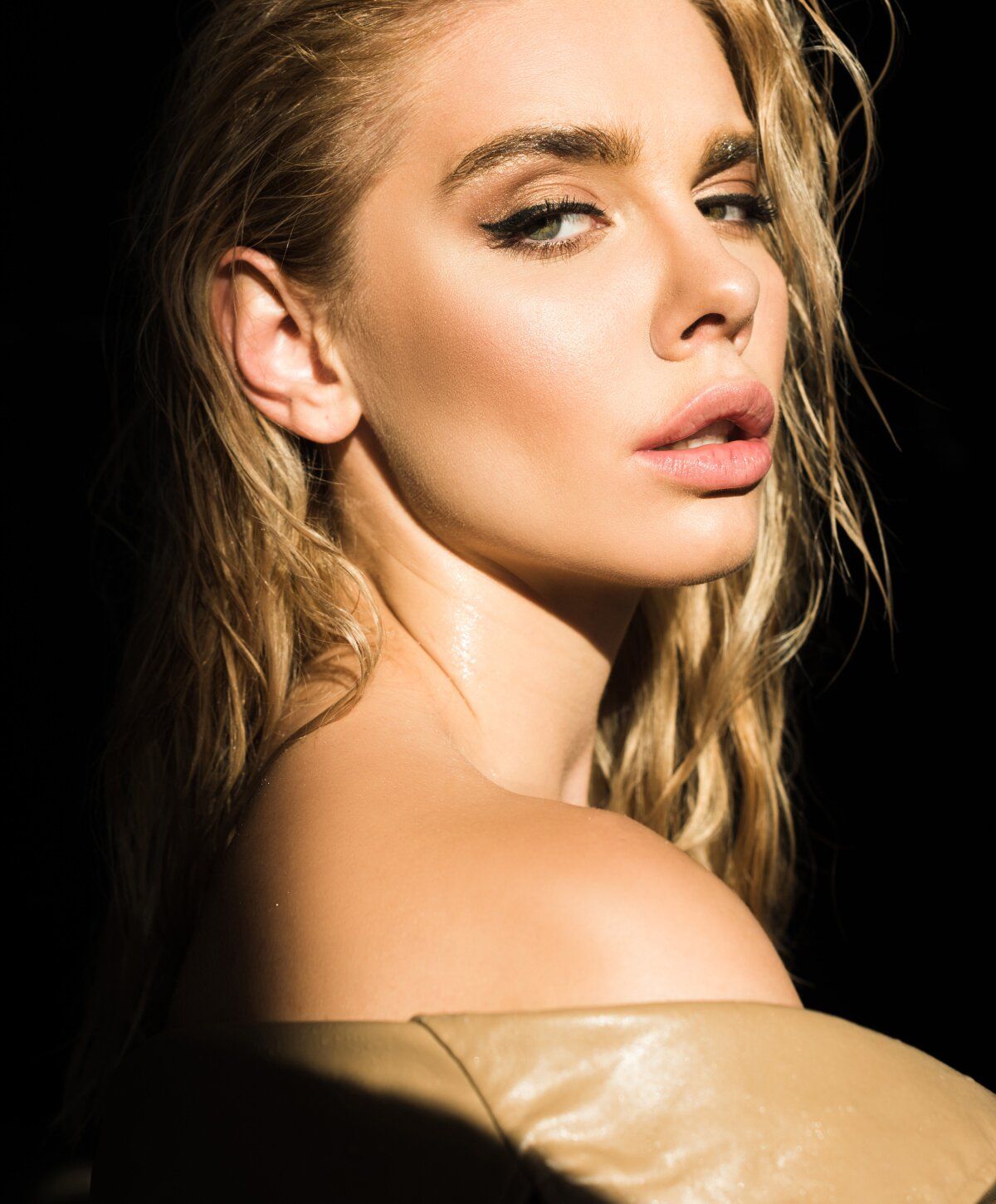 Portrait of a woman with wet, wavy hair.