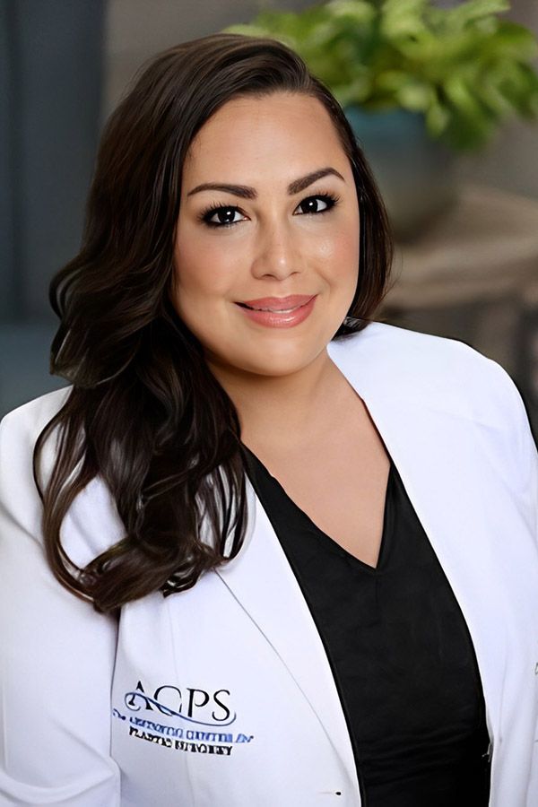 Smiling woman in medical coat portrait.