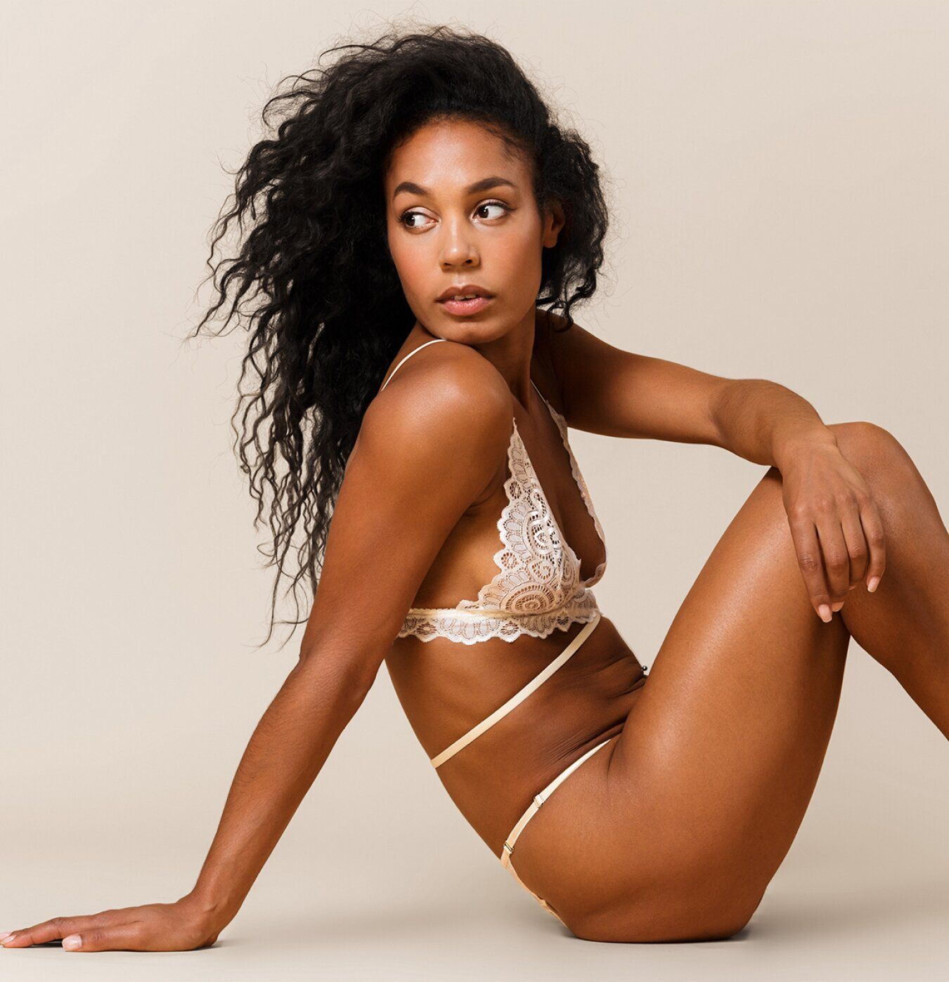 Model in lingerie posed against a neutral background.