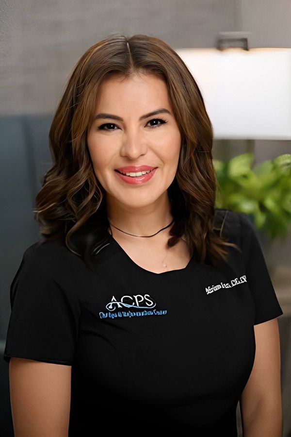 Smiling woman in professional black shirt.