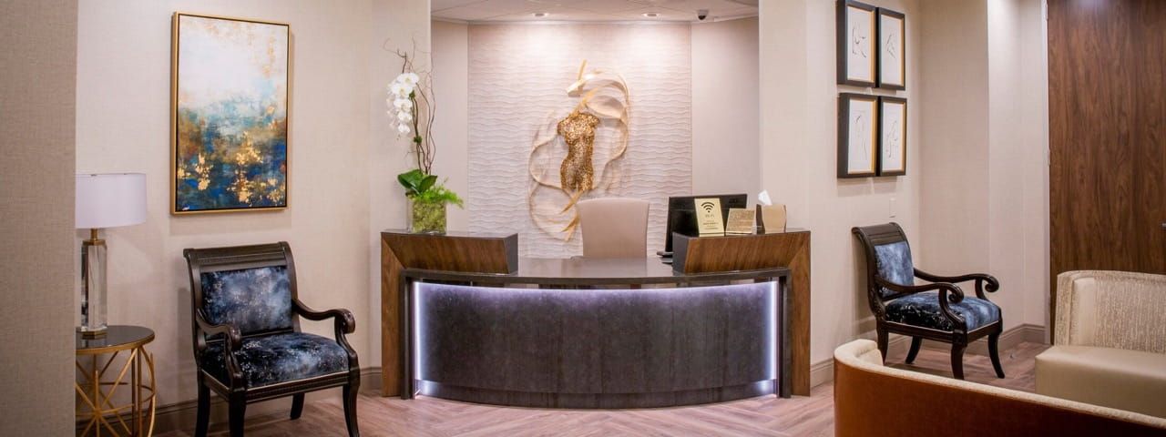 Modern reception area with elegant decor and seating.