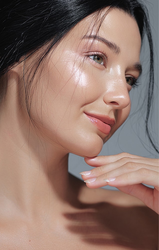 Close-up of a woman’s face, glowing skin.