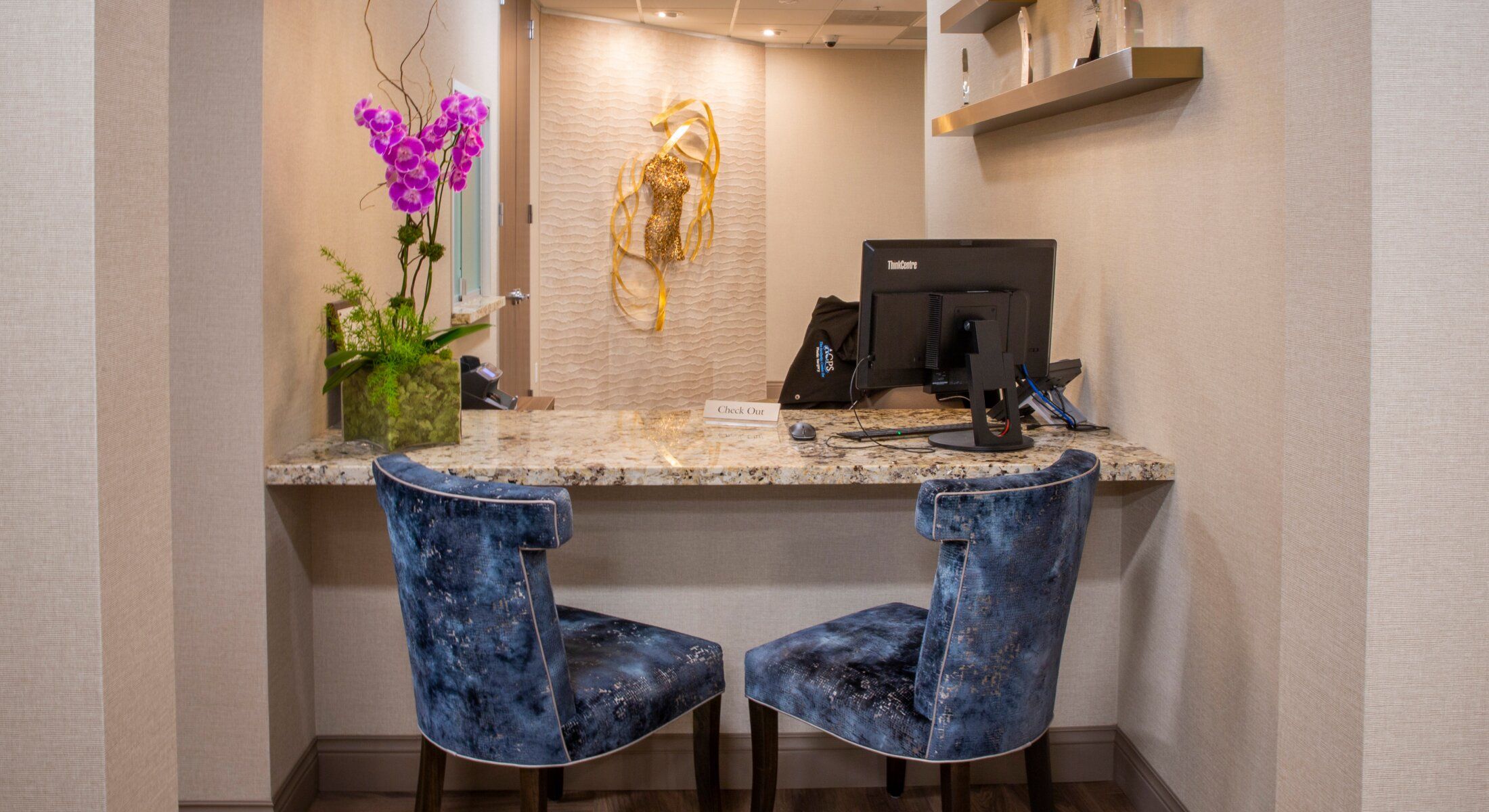 Reception area with chairs and computer station.