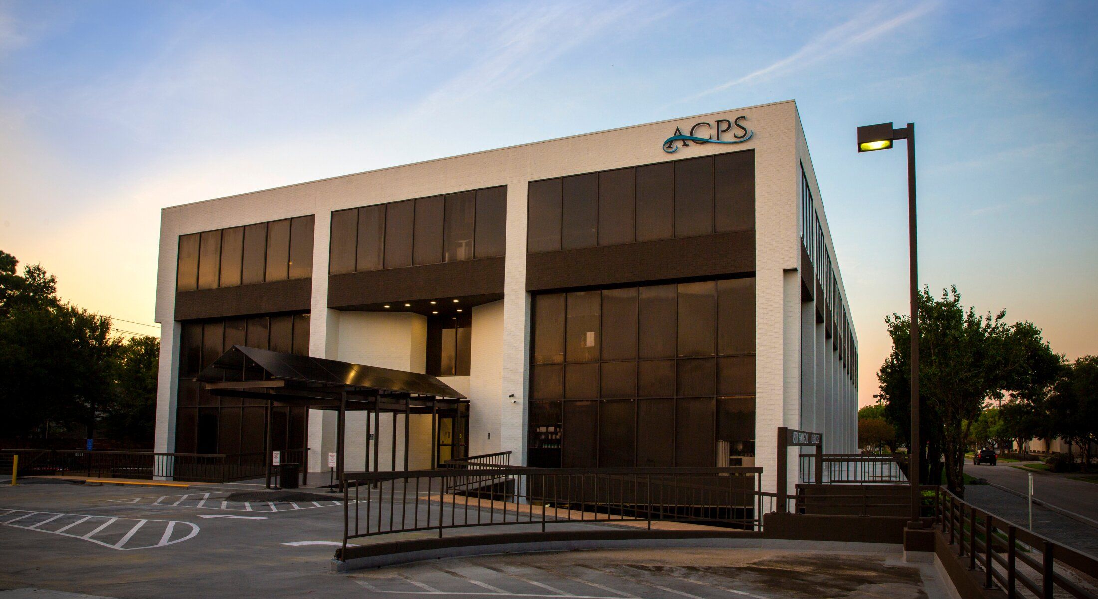 Modern office building with ACPS signage.