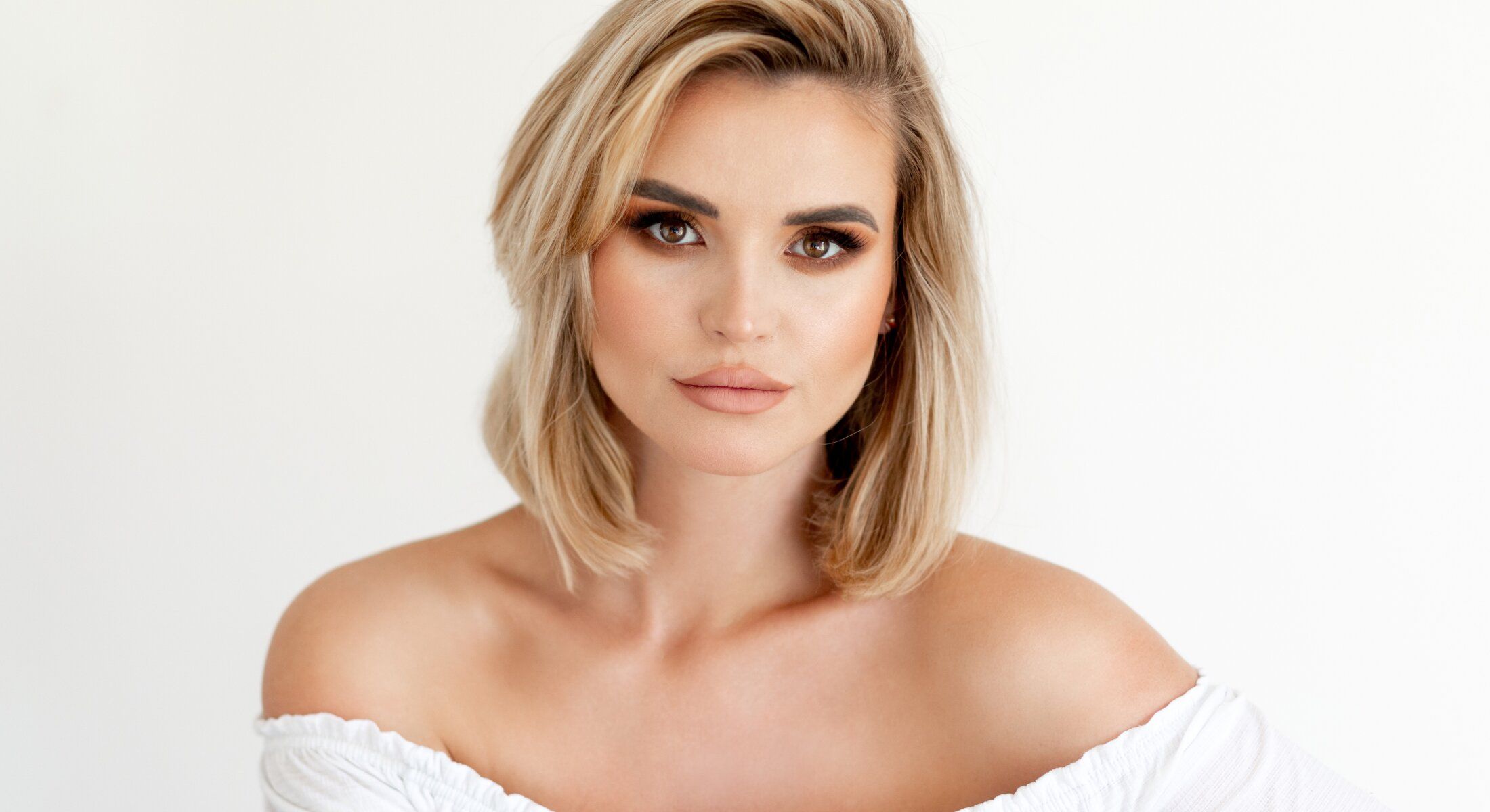 Woman with short blonde hair and natural makeup